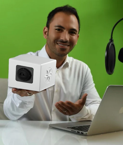 Nima Farshid, a holistic wellness practitioner displaying Bio-Well 3.0 device